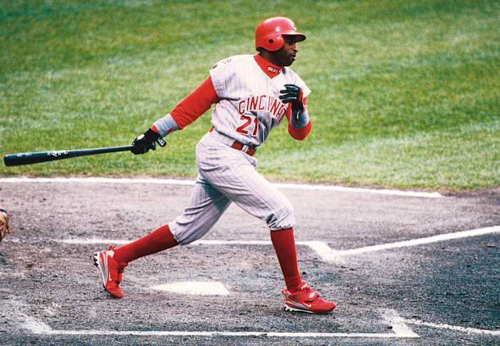 Deion Sanders swings during a baseball game.